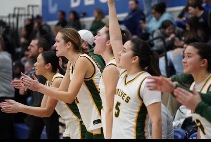 From L-R: Tera Chen, Avery Knapp, Hania Bowes, Amanda Kerner and Sierra Chambers cheering on teammates during another Wolves' victory.